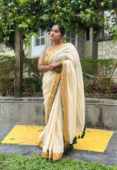 Black and gold bordered beige mul cotton saree