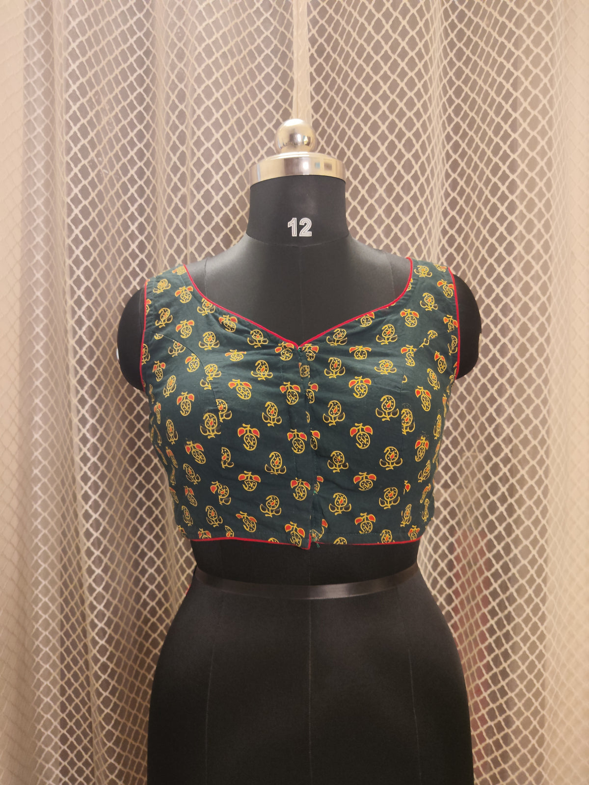 Bottle green Ajrakh backless sleeveless blouse with red piping