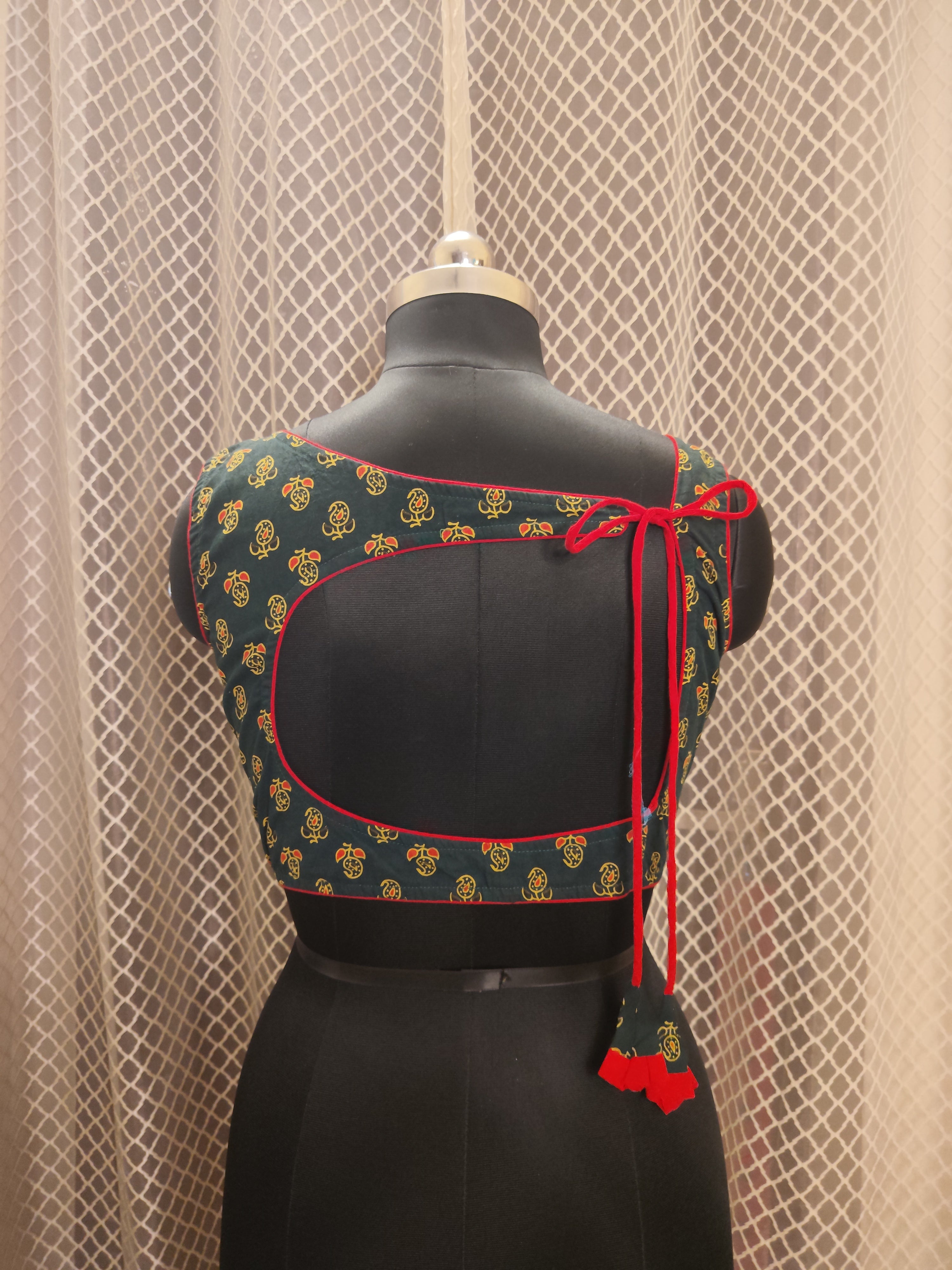 Bottle green Ajrakh backless sleeveless blouse with red piping