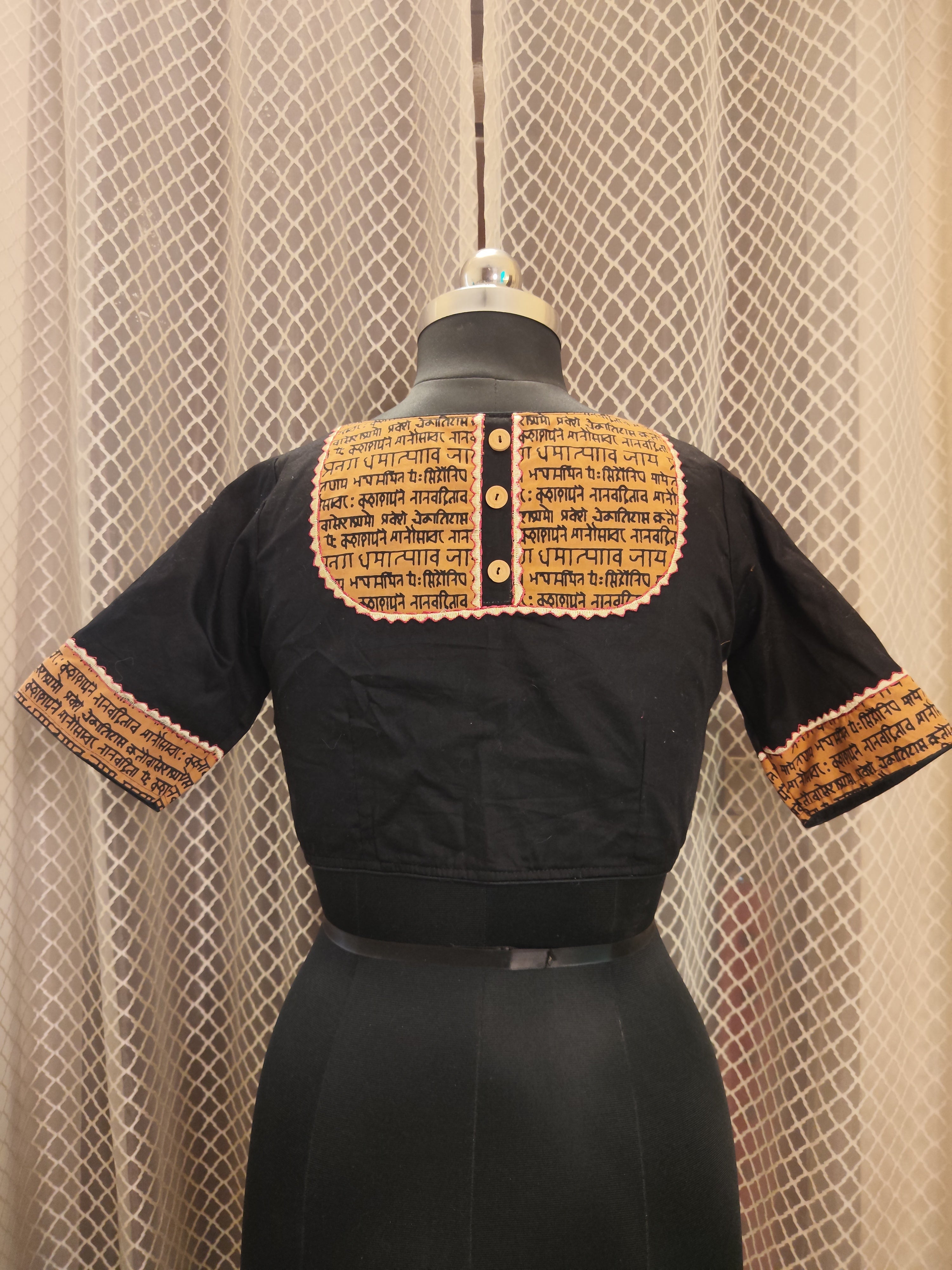 Black cotton blouse with embroidery and script patch work