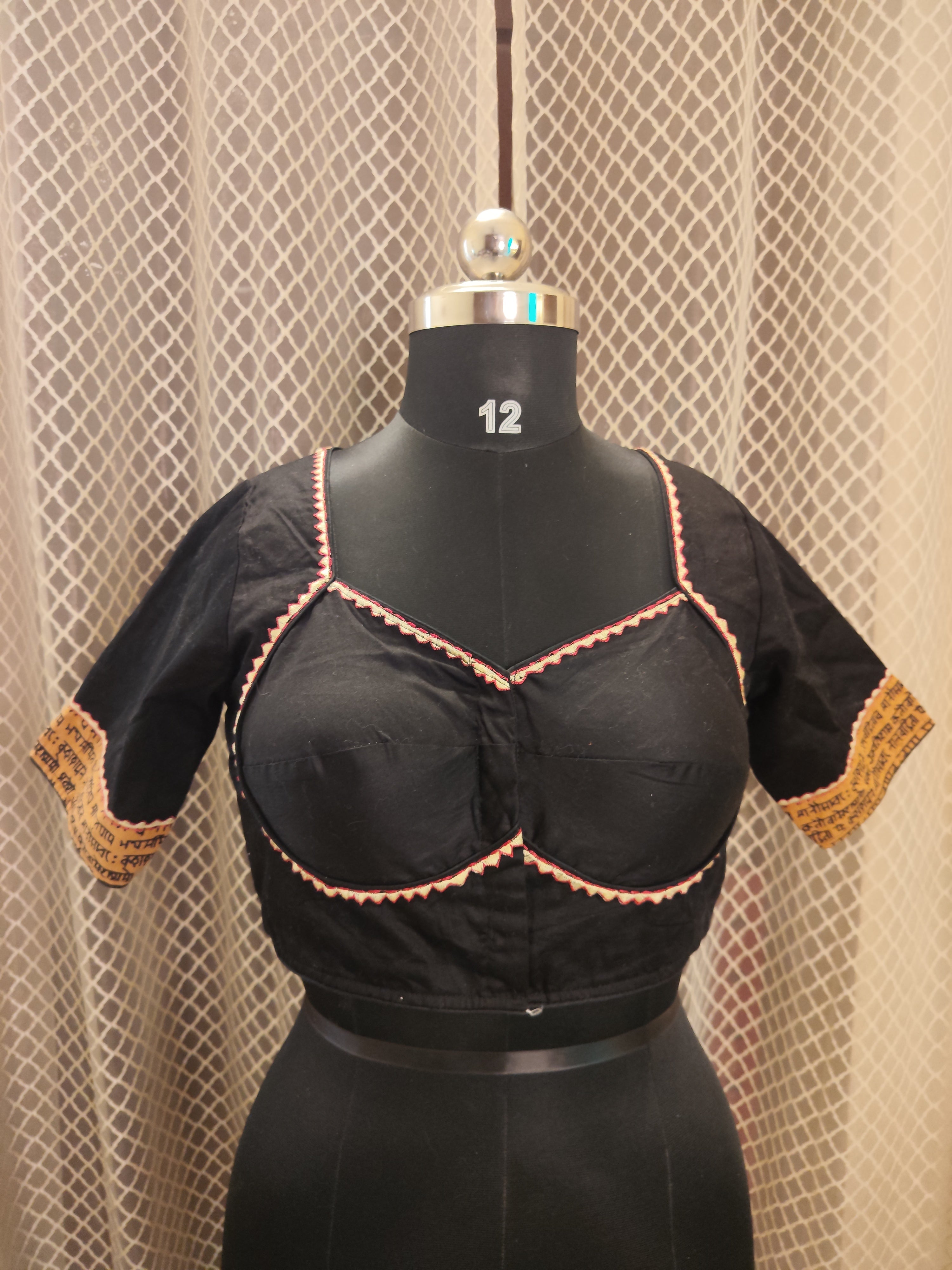 Black cotton blouse with embroidery and script patch work