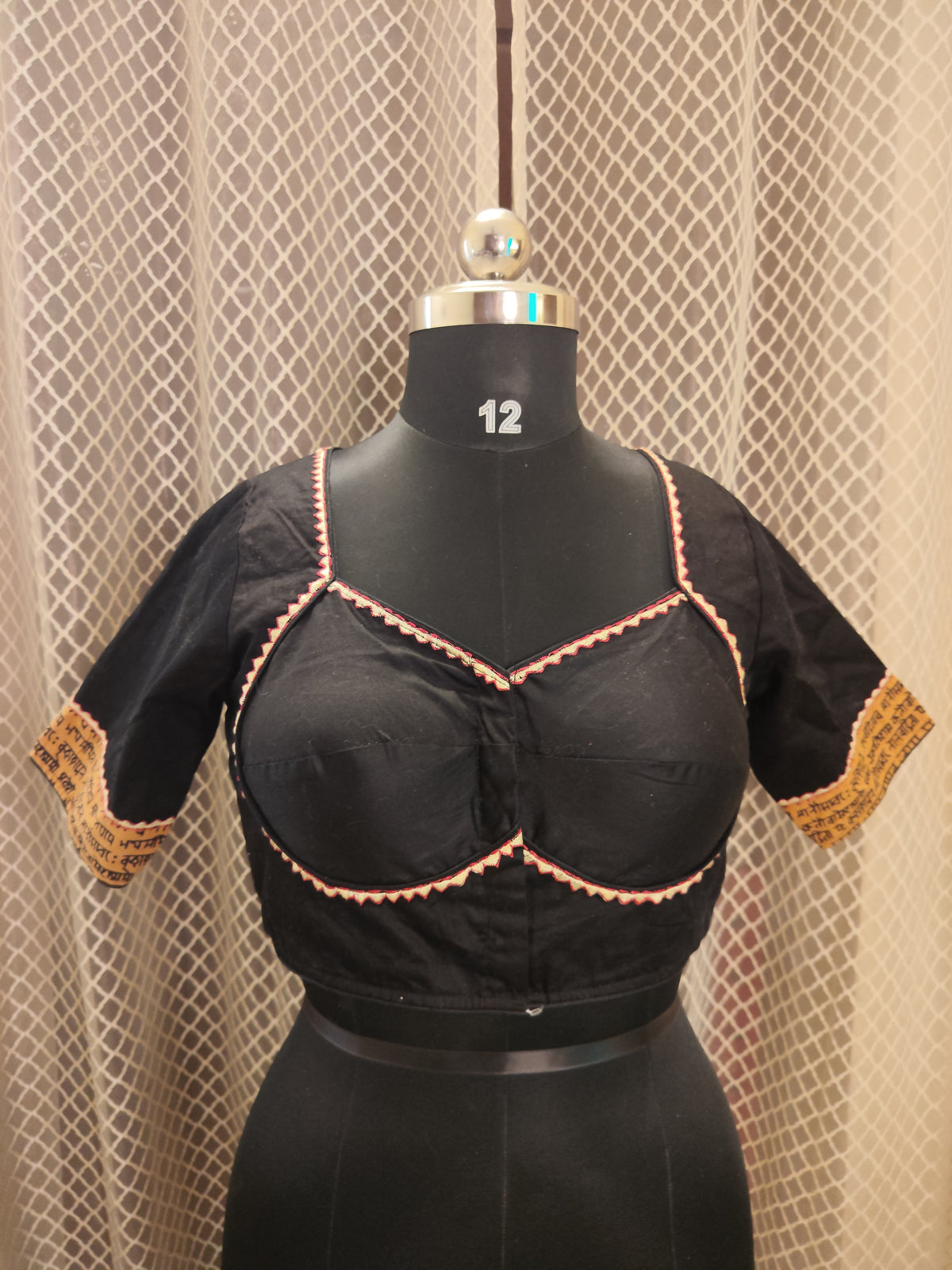 Black cotton blouse with embroidery and script patch work