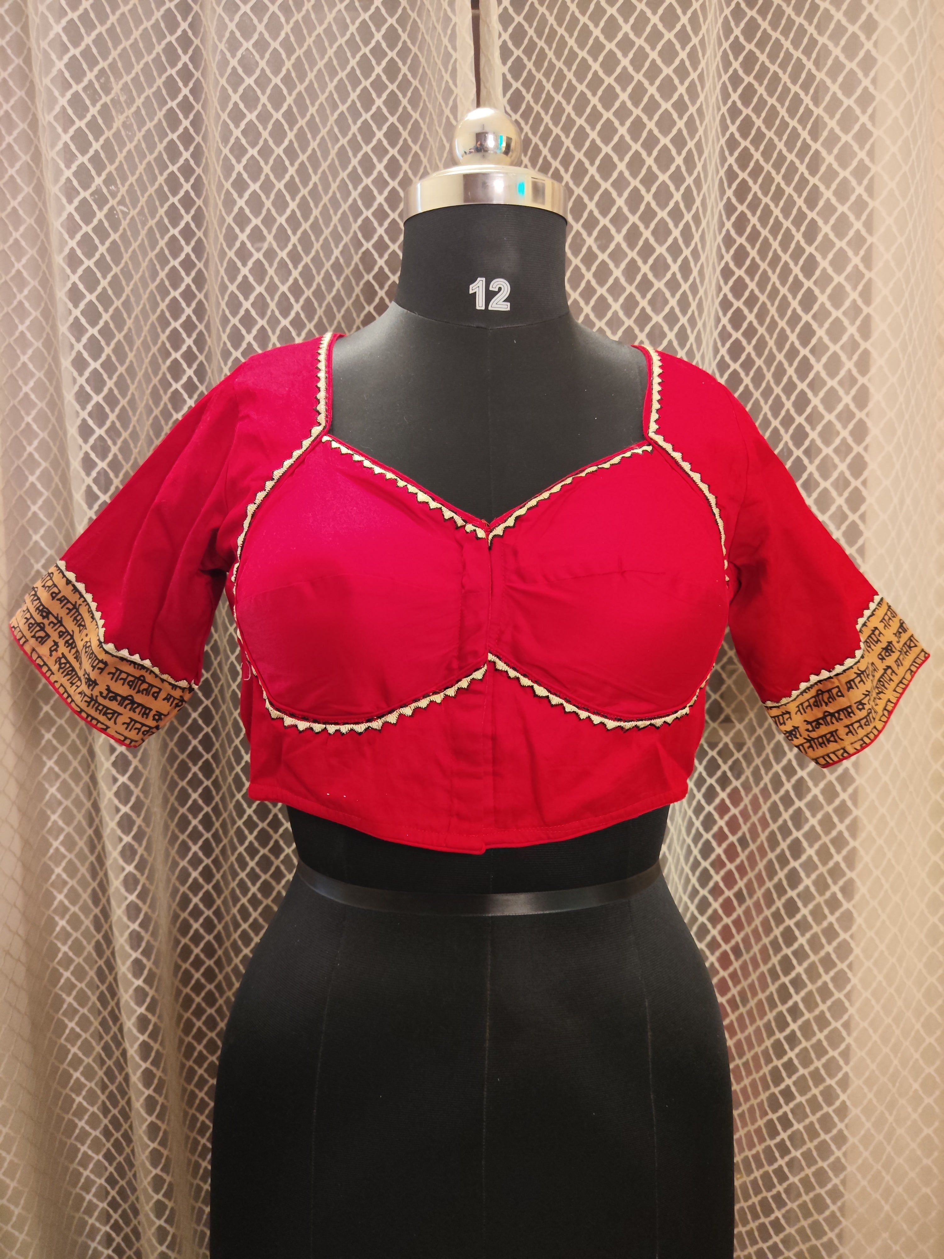 Red cotton blouse with embroidery and script patch work