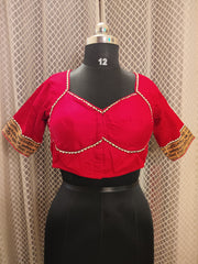 Red cotton blouse with embroidery and script patch work